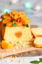 Orange Pound Cake flavored with freshly squeezed orange juice and zest decorated with dried apricots, mint and almonds