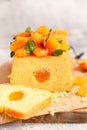 Orange Pound Cake flavored with freshly squeezed orange juice and zest decorated with dried apricots, mint and almonds