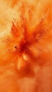 Orange powder explosion, dynamic burst of color. Abstract art and creativity concept Royalty Free Stock Photo