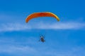Orange powered tandem para glider flying Royalty Free Stock Photo
