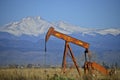 Orange Pump Jack Oil Well and Longs Peak Royalty Free Stock Photo