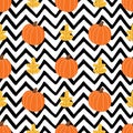 Orange pumpkin, autumn leaves on black zigzag lines background. Simple Halloween seamless pattern