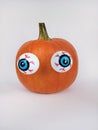 Orange pumpkin with big eyes on a white background Royalty Free Stock Photo