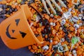 Halloween candy spilling out of orange pumpkin bucket