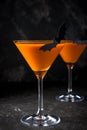 Orange pumpkin martini Halloween drink for party over black background. copy space Royalty Free Stock Photo