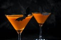 Orange pumpkin martini Halloween drink for party over black background. copy space Royalty Free Stock Photo