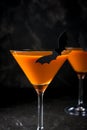 Orange pumpkin martini Halloween drink for party over black background. copy space Royalty Free Stock Photo