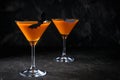 Orange pumpkin  martini Halloween drink for party over black background with  copy space Royalty Free Stock Photo