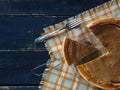 Orange pumpkin round pie.Natural vegetarian dessert on a dark wooden background. Top view, flat styling