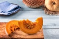 Orange pumpkin slices on olive tree cutting board Royalty Free Stock Photo