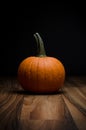 Orange pumpkin on wood surface