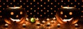 Orange pumpkins as a head with carved eyes and a smile with candles on a black background with a garland to the Halloween party Royalty Free Stock Photo