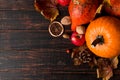 Orange pumpkins, fallen leaves, apples, nuts, berries on wooden background. Concept autumn template, blank halloween or Royalty Free Stock Photo