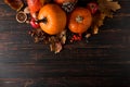 Orange pumpkins, fallen leaves, apples, nuts, berries on wooden background. Concept autumn template, blank halloween or Royalty Free Stock Photo