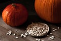 Orange pumpkins and pumpkin seeds on a wooden table, still life rustic style Royalty Free Stock Photo