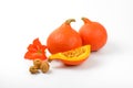 Orange pumpkins with walnuts and hibiscus flower Royalty Free Stock Photo