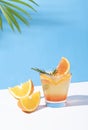 Orange punch cocktail cold and refreshing with orange slice on color background. summer drink