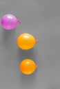 Orange purple balloons gray background