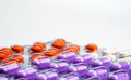 Orange, purple and white tablets pills in blister pack on white background. Colorful medicine for relieve pain. NSAIDs drug Royalty Free Stock Photo