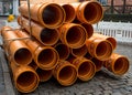 Orange PVC pipes stacked in construction site Royalty Free Stock Photo