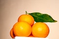 Orange pyramid with green leaves, drying.