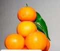 Orange pyramid with green leaves, drying.