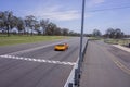 Orange racing car about to finish