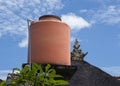 Orange rain water storage container on roof Royalty Free Stock Photo