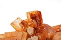 Orange red aragonite crystal on white background