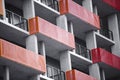 Orange and red balconies on modern concrete high-rise building w Royalty Free Stock Photo