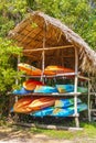 Orange red blue canoes Muyil Lagoon boat trip in Mexico