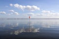 Orange red flag floating in water as marker