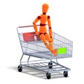 An orange red manikin sitting in a ahopping cart