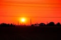 orange red morning sunshine, sunrise over oil industry petroleum refinery skyline with many tall chimneys, high voltage power line Royalty Free Stock Photo