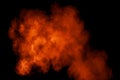 Orange red  powder explosion on black background.Orange red color dust splash clouds Royalty Free Stock Photo