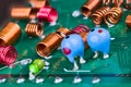 Orange and red radio-frequency coils or blue tantalum capacitors on a printed circuit board Royalty Free Stock Photo