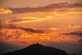 Orange-red sky, sunset and silhouettes of mountains. Royalty Free Stock Photo