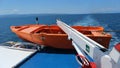Orange rescue boat on a passenger ship cruising in the Aegean Sea on a sunny day
