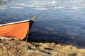 Orange rescue boat on the shore of a frozen lake