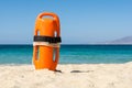 Orange rescue buoy on the beach Royalty Free Stock Photo