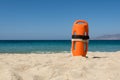 Orange rescue buoy on the beach Royalty Free Stock Photo