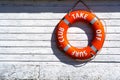 Orange rescue float. Lifebuoy on the wall of the building of the rescue station