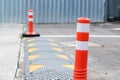 Orange restrictive poles on the road closeup