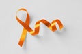 Orange ribbon on white background - Concept of leukemia awareness, kidney cancer association, multiple sclerosis and animal abuse Royalty Free Stock Photo