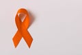 Orange ribbon on white background . Healthcare and medicine concept. Multiple Sclerosis awareness. Leukemia awareness. Empty text Royalty Free Stock Photo