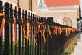 Orange ribbons tied to a wrought iron fence outside Saint Mary`s Cathedral, Winnipeg, Manitoba, Canada Royalty Free Stock Photo