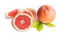 Orange ripe grapefruit whole and sliced with leaves on a white background.