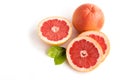 Orange ripe juicy grapefruit whole and cut with leaves on a white background.