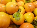 Orange ripe kaki fruit in the market