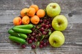 Orange riped peaches, green apples, red gooseberries and sour cherries